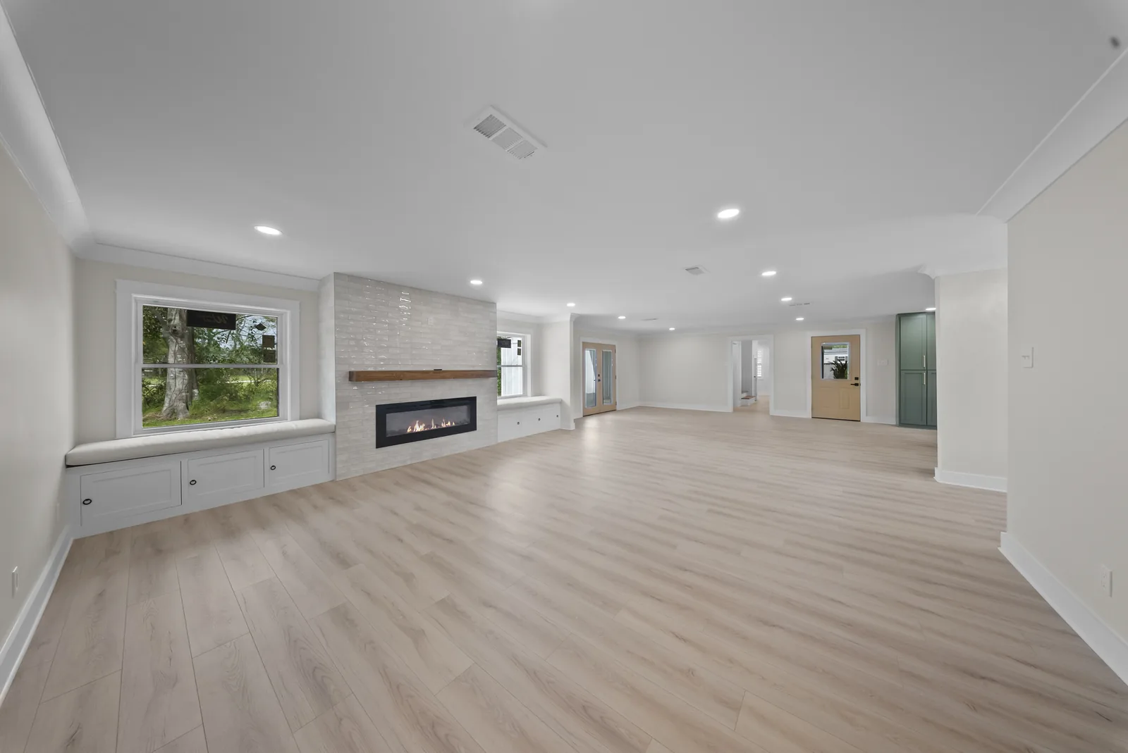 Completed open living space with new flooring and built-in storage
