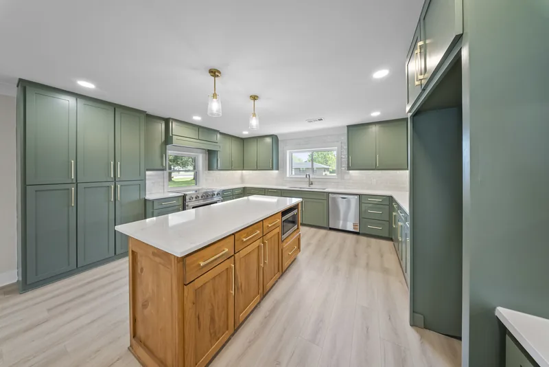 Completed kitchen with custom green cabinetry