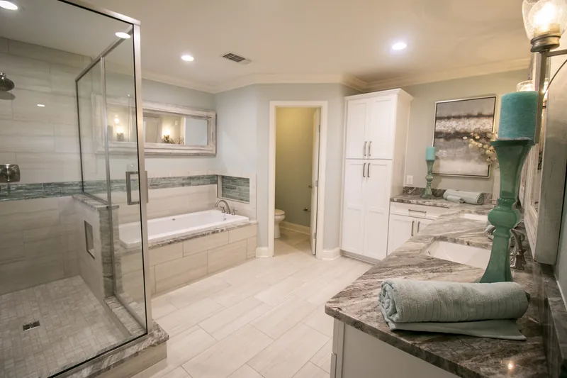 Remodeled bathroom with glass shower and double vanity