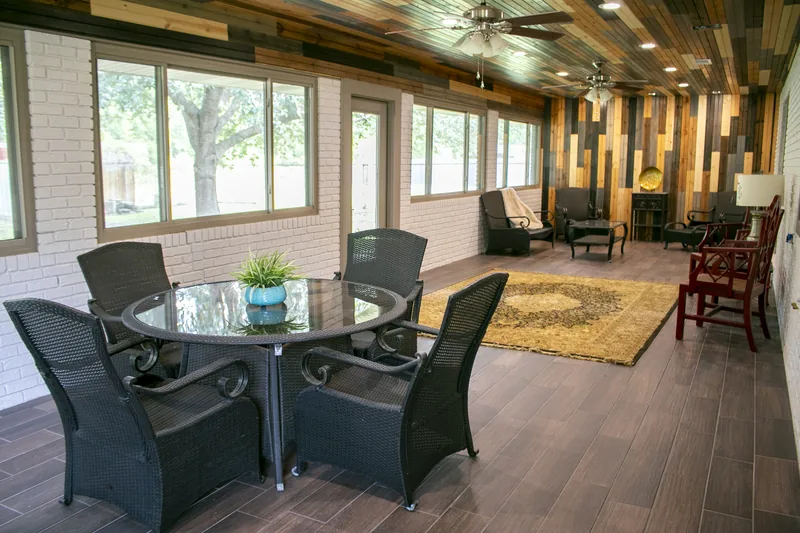 Finished enclosed porch with mixed wood ceiling and tile floor