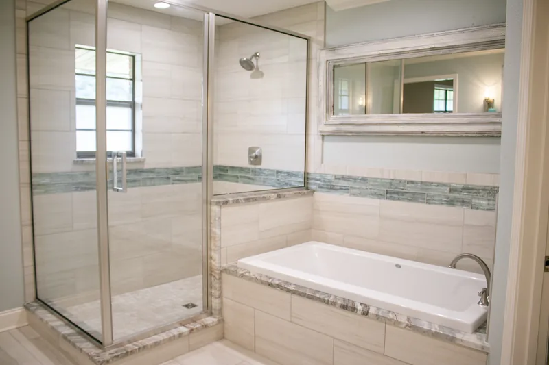 Glass shower and soaking tub with a tiled surround