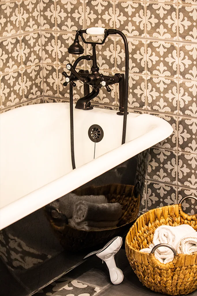 Claw-foot tub with patterned tile wall