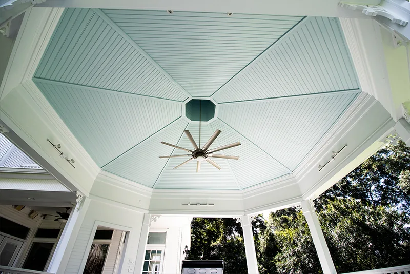 Vaulted paneled gazebo ceiling with a ceiling fan