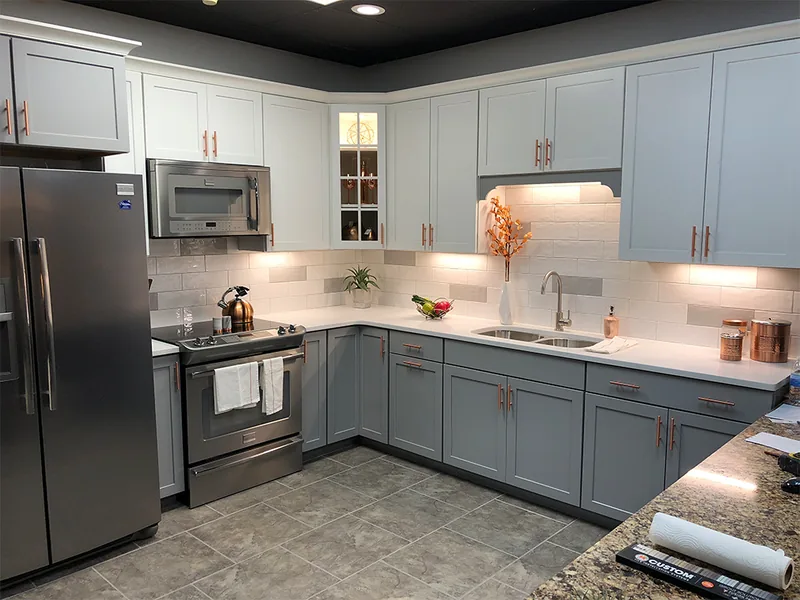 Remodeled kitchen with blue-gray cabinets and stainless steel appliances