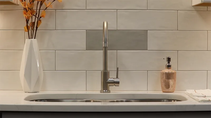 Modern kitchen sink with a large-format tile backsplash